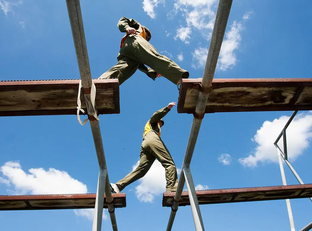 British Army cadets negotiating an outdoor obstacle course